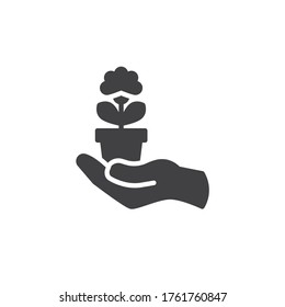 Hand holding flower pot vector icon. filled flat sign for mobile concept and web design. Hand with potted plant glyph icon. Symbol, logo illustration. Vector graphics