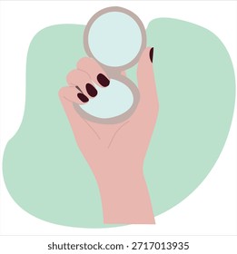 hand holding a folding vanity mirror
