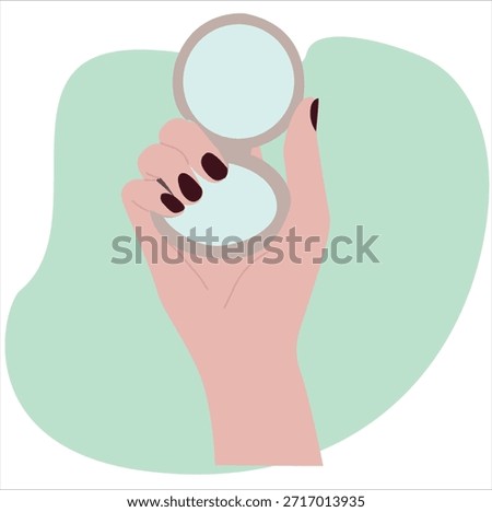 hand holding a folding vanity mirror