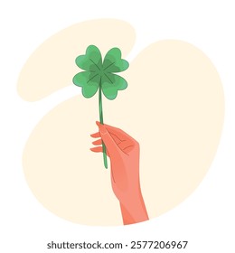 Hand holding a four-leaf clover for good luck concept