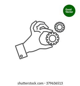 Hand holding gear wheels