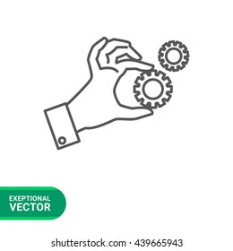 Hand holding gear wheels