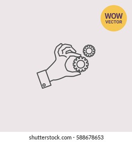 Hand holding gear wheels