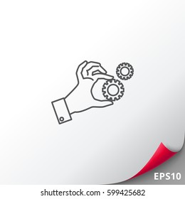 Hand holding gear wheels