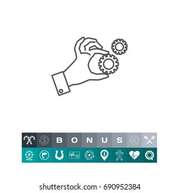 Hand holding gear wheels