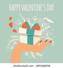 Hand holding a gift box with hearts coming out, decoration and typographic message. Colorful hand drawn illustration for Happy Valentine’s day. Greeting card with foliage and decorative elements. 