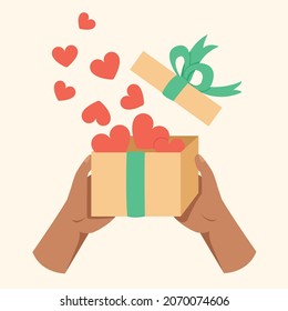Hand, die Geschenkbox, die Eröffnungsbox oder das Entpacken mit Herzenskonzept.