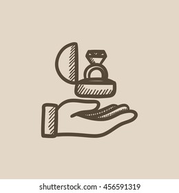 Hand holding gift box with ring vector sketch icon isolated on background. Hand drawn Hand holding gift box with ring icon. Hand holding gift box with ring sketch icon for infographic, website or app.