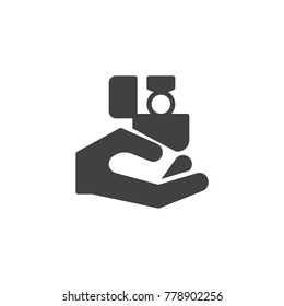 Hand holding gift box with ring icon vector, filled flat sign, solid pictogram isolated on white. Engagement symbol, logo illustration.