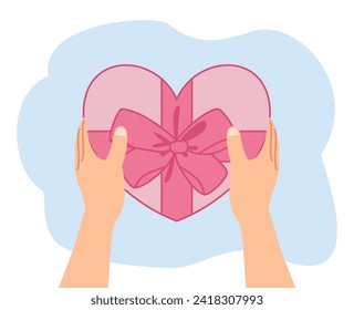 hand holding gift box shape heart for valentine day