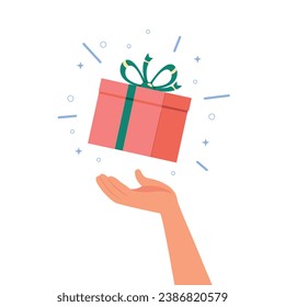 Hand holding gift boxes flying and falling, holiday surprise box. 