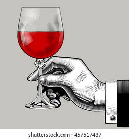 Hand Holding A Glass With Red Wine. Vintage Engraving Stylized Drawing. Vector Illustration