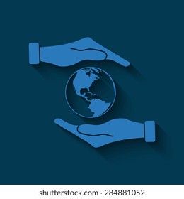 Hand holding Globe earth  with shadow on a blue background