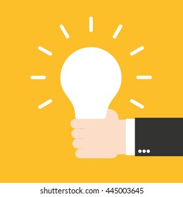 Hand holding glowing light bulb. Business idea concept