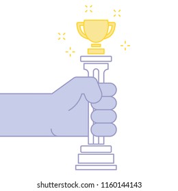 Hand holding Golden cup trophy.