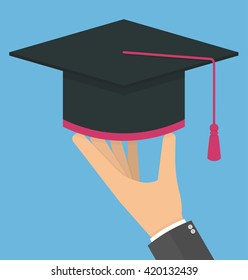 Hand holding graduation cap. Flat design