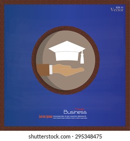 Hand holding a graduation cap on a chalkboard background.