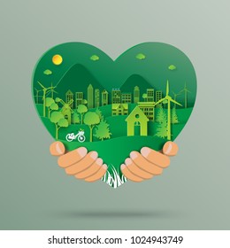 Hand holding green heart with urban forest and eco city abstract paper art background.Ecology and environment conservation with love nature concept.Vector illustration.