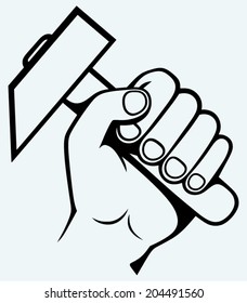 Hand holding hammer. Image isolated on blue background