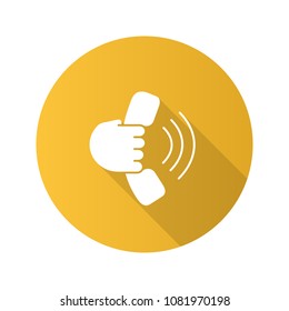 Hand holding handset flat design long shadow glyph icon. Answering the call. Hotline. Vector silhouette illustration