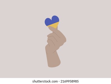 A hand holding a heart colored as a Ukrainian flag, Support Ukraine