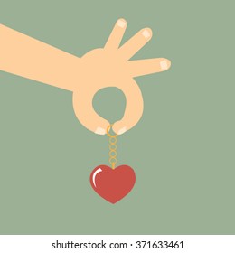 Hand holding heart keychain-vector