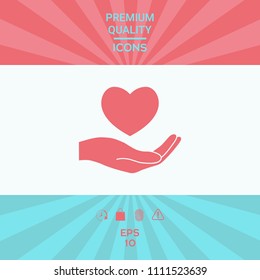 Hand holding heart symbol
