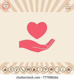 Hand holding heart symbol