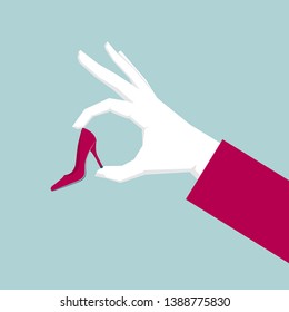 Hand holding high heels. Isolated on blue background.