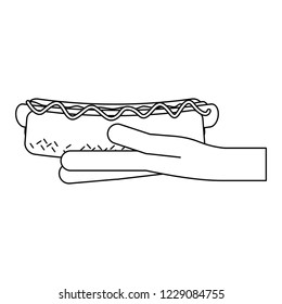 Hand holding hot dog black and white