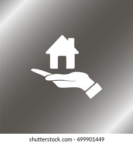Hand holding house.