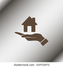 Hand holding house.