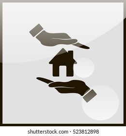 Hand holding house.