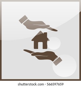 Hand holding house.