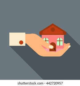 Hand holding house icon in flat style with long shadow. Real estate symbol