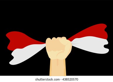 Hand Holding Indonesia Flag at black background
