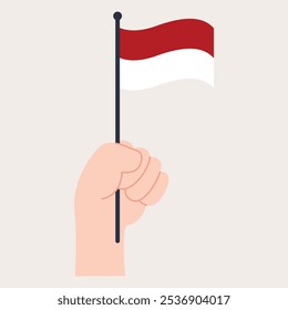 A hand holding the Indonesian flag, symbolizing national pride.