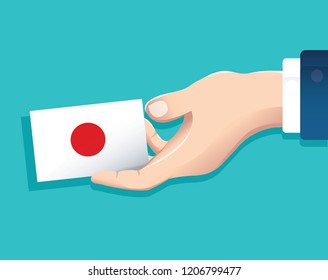 hand holding Japan flag card with blue background. vector illustration eps10
