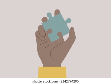 A Hand Holding A Jigsaw Puzzle Piece, Trouble Shooting And Teamwork