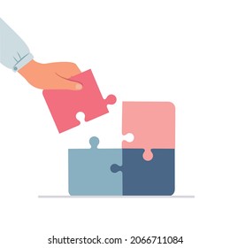 Hand holding jigsaw puzzles, teamwork concept.