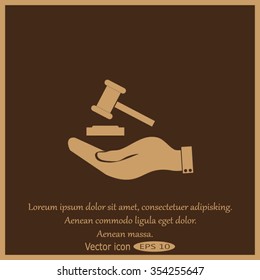 Hand holding judges gavel.