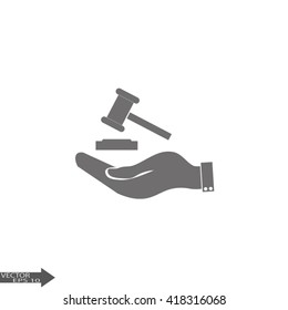Hand holding judges gavel.