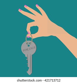 Hand holding the key. 