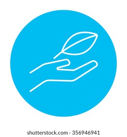 Hand holding a leaf line icon for web, mobile and infographics. Vector white icon on the light blue circle isolated on white background.