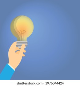Hand holding a light bulb