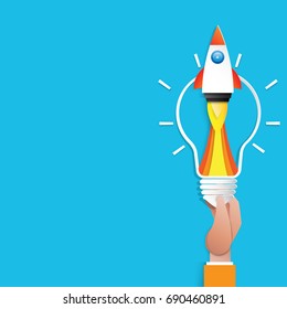 Hand Holding Light Bulb And Rocket Ship Icon.Business Start Up Concept Paper Art Style Design.Vector Illustration.