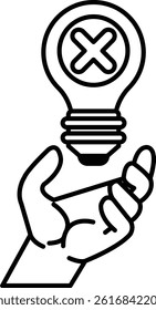 A hand holding a light bulb with an X on it