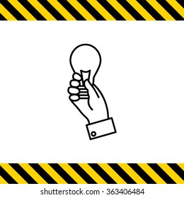 Hand holding lightbulb
