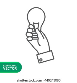 Hand holding lightbulb