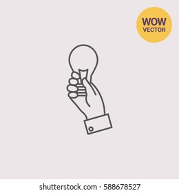 Hand holding lightbulb